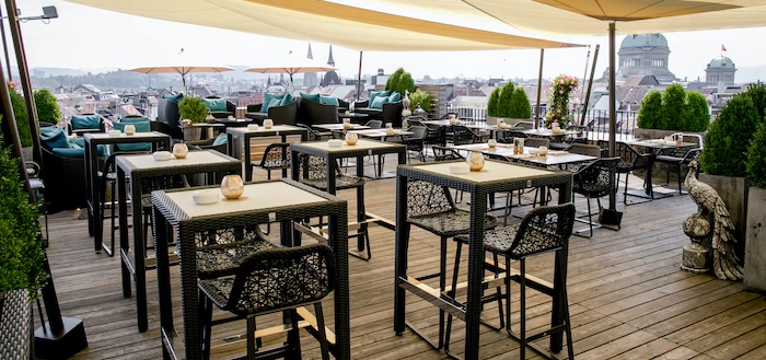 Outdoor market scene with a chef and customer, set against a historic building with turrets; encapsulates a vibrant, communal atmosphere in urban food culture.