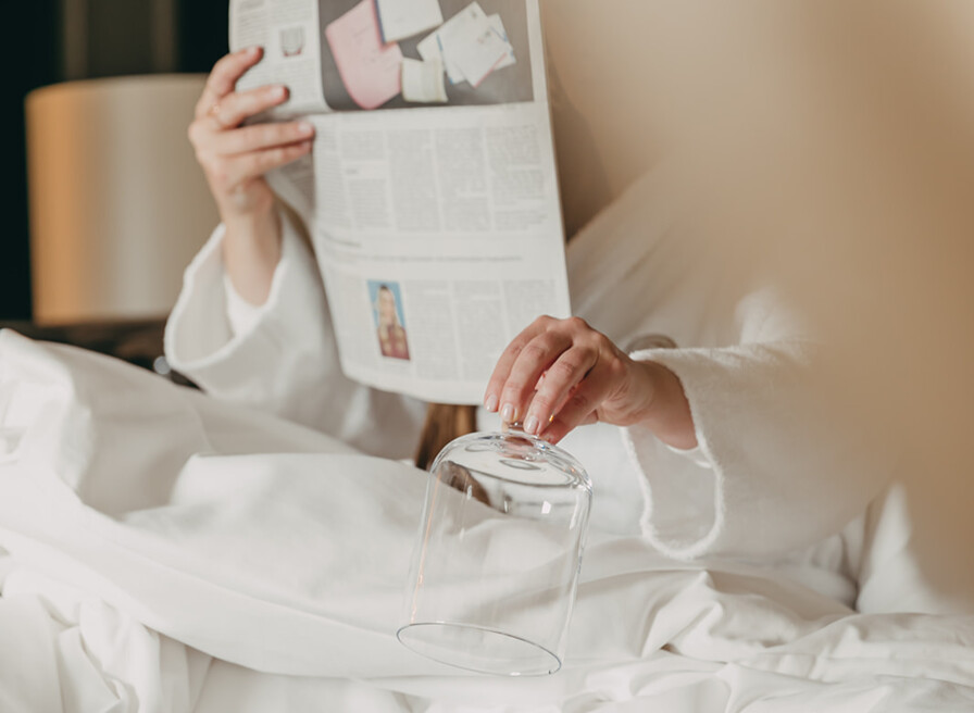 Majestic Royal Savoy Hotel facade with lush green gardens, offering an elegant and serene ambiance for travelers.